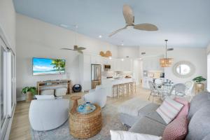 a living room and kitchen with a couch and a table at Captiva Hide A Way 2D in Captiva