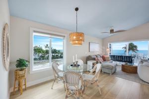 a living room with a table and chairs and a couch at Captiva Hide A Way 2D in Captiva