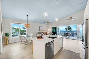 a kitchen and living room with a view of the ocean at Captiva Hide A Way 2D in Captiva +22 photos