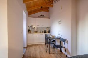 a kitchen with a table and chairs in a room at Voidοkilia rooms in Petrochori