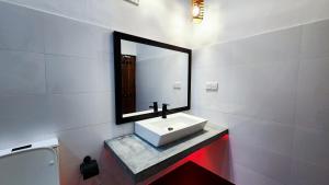 a bathroom with a sink and a mirror at Euro Elephant Yala in Tissamaharama +45 photos