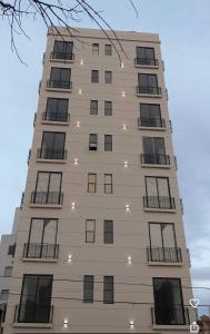 a tall building with lights on the side of it at Departamento de lujo inteligente in Cochabamba