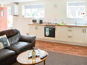 a living room with a couch and a table at Swan's Nest - Uk43545 in Belford