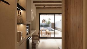a kitchen and dining room with a table and chairs at ARC suites in Mylopotas