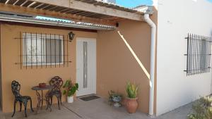 a patio with chairs and a table in front of a house at Abuela Chiquita in Ramallo