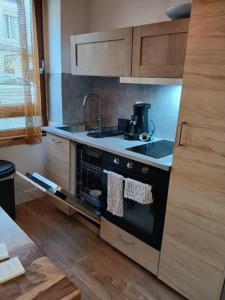 a kitchen with a black stove top oven in a kitchen at Le wine studio Gevrey-Chambertin in Gevrey-Chambertin +21 photos