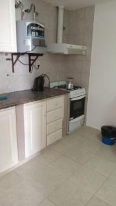a kitchen with a stove and a microwave at Abuela Chiquita in Ramallo