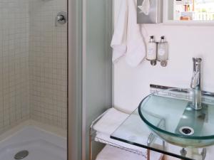 a bathroom with a glass sink and a shower at Knock Out View Clarens in Clarens +71 photos
