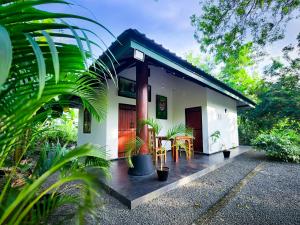 a small white house with tables and chairs at Euro Elephant Yala in Tissamaharama