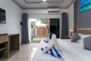 a bedroom with a bed with a towel on it at Hidden Tide Villa in Ukulhas +16 photos