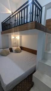 a bedroom with a bed under a staircase at Bird Park Villa Ella in Ella