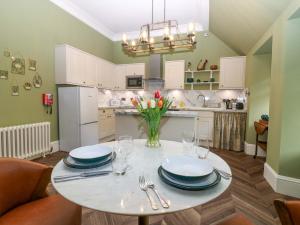a kitchen with a table with plates and glasses at Braeriach - Mar Lodge Estate in Ballater
