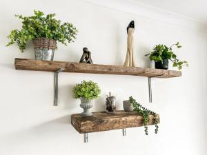 a pair of wooden shelves with plants on a wall at Highcross in Poulton le Fylde