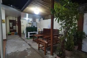 a room with two wooden benches and a table at Little Haven at Lio in El Nido +45 photos