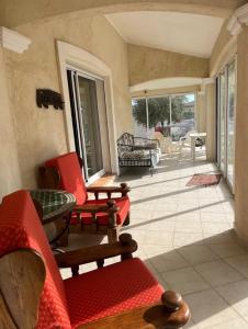 a living room with red furniture and a patio at Le Clos des Galets in Meynes +4 photos