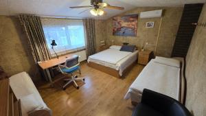 a bedroom with a bed and a desk and a bed and a chair at ApartHotel SAVAS 4 Private house with parking in Kaunas