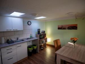a kitchen with a wooden table and a dining room at Ferienwohnung Wieck Greifswald in Wieck
