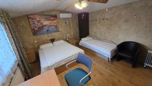 a room with two beds and a table and chairs at ApartHotel SAVAS 4 Private house with parking in Kaunas