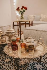 a living room with a table with cups and a tea set at Riad Dar Home in Tétouan