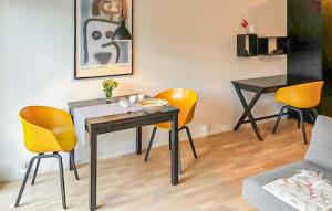 a dining room with yellow chairs and a table at 1 Bedroom Nice Apartment In Helsingør in Helsingør
