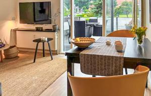 a living room with a television and a table with chairs at 1 Bedroom Nice Apartment In Helsingør in Helsingør