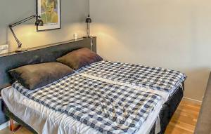 a bedroom with a bed with a checkered blanket at 1 Bedroom Nice Apartment In Helsingør in Helsingør +3 photos