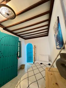 a bedroom with blue doors and a bed in a room at Riad Dar Home in Tétouan