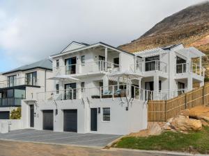a white house on top of a hill at Arc Guest House in Simonʼs Town