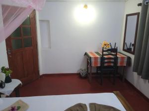 a room with a table and a table and a door at Breeze House in Hikkaduwa