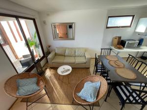 a living room with a couch and a table and chairs at Cabañas Bellavista del mar in De Cauquenes
