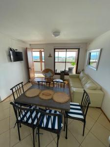 a living room with a table and chairs and a couch at Cabañas Bellavista del mar in De Cauquenes