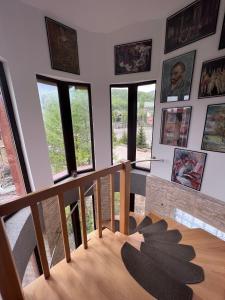a room with a wooden table and some windows at Pensiunea Silvian in Cheia