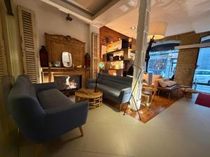 a living room with a couch and a fireplace at Abalú Collection Hotel Boutique Gran Via in Madrid