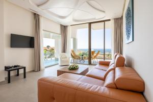 a living room with a couch and a view of the ocean at Le Tanger Résidence Hôtelière in Tangier +177 photos
