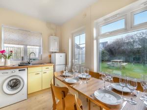 a kitchen with a table with wine glasses on it at Arosfa in St. Davids