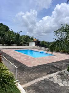 a swimming pool in the middle of a yard at Nethra Darshan in Mangalore
