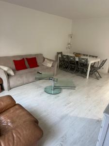 a living room with a couch and a table at Disney 4 min, from 4 to 14 Guests, 4 bedrooms, free parkings, 100 m2 in Chessy