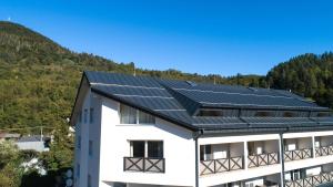 a building with solar panels on the roof at Apartmán Timea v Terchovej in Terchová