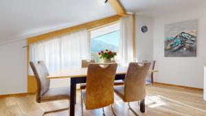 a dining room with a table and chairs and a window at Apartmán Timea v Terchovej in Terchová +34 photos