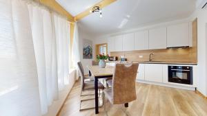 a kitchen with a table and chairs in a room at Apartmán Timea v Terchovej in Terchová