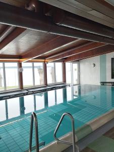 a large swimming pool with a large window at 1A Landhotel Schicklberg in Kremsmünster