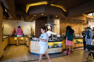 a group of people in a kitchen preparing food at Al Dora Boutique Hotel in Hurghada +142 photos