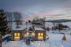 a house in the snow with lights on at Cicho Sza in Tylicz