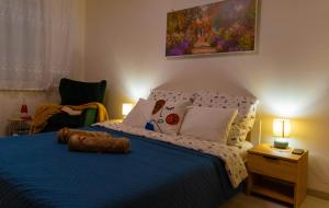 a bedroom with a bed with blue sheets and pillows at LM Apartman in Spišská Nová Ves