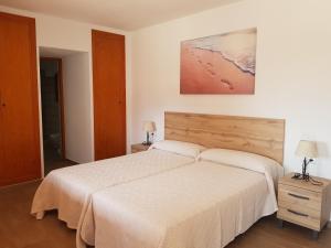 a bedroom with a large bed and two lamps at Casa Sol in Santa Eularia des Riu +22 photos