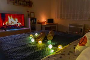 a bedroom with a bed with christmas lights on it at LM Apartman in Spišská Nová Ves