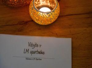 a ring sitting on top of a table with a sign at LM Apartman in Spišská Nová Ves +11 photos
