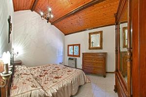 a bedroom with a bed and a wooden ceiling at Podere Riosto Cantina&Agriturismo in Pianoro +50 photos