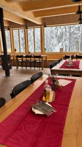 a dining room with a table with a red table cloth at Horská chata Libín in Prachatice