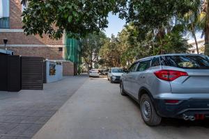 a silver car parked on the side of a street at Itsy Hotels Saina Stay Near 32 Milestone in Gurgaon